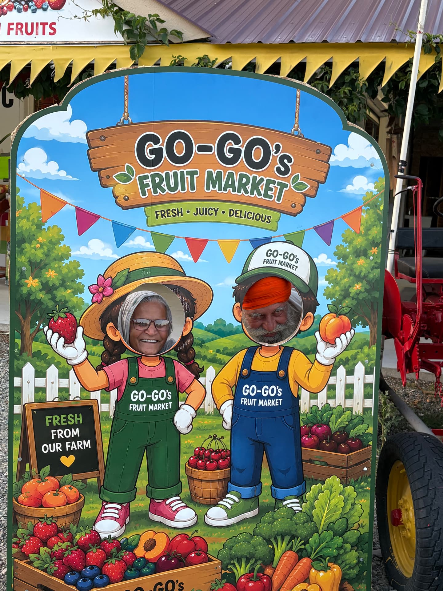 Go-Go's Fruit Market photo cutout board with a smiling couple