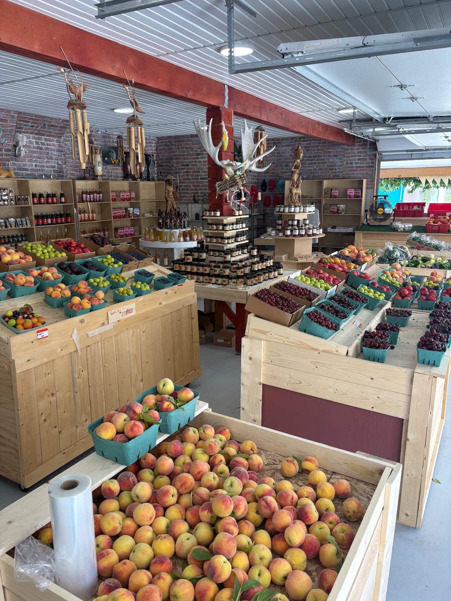 Inside Go-Go's Fruit Market with crates of peaches, cherries and preserves